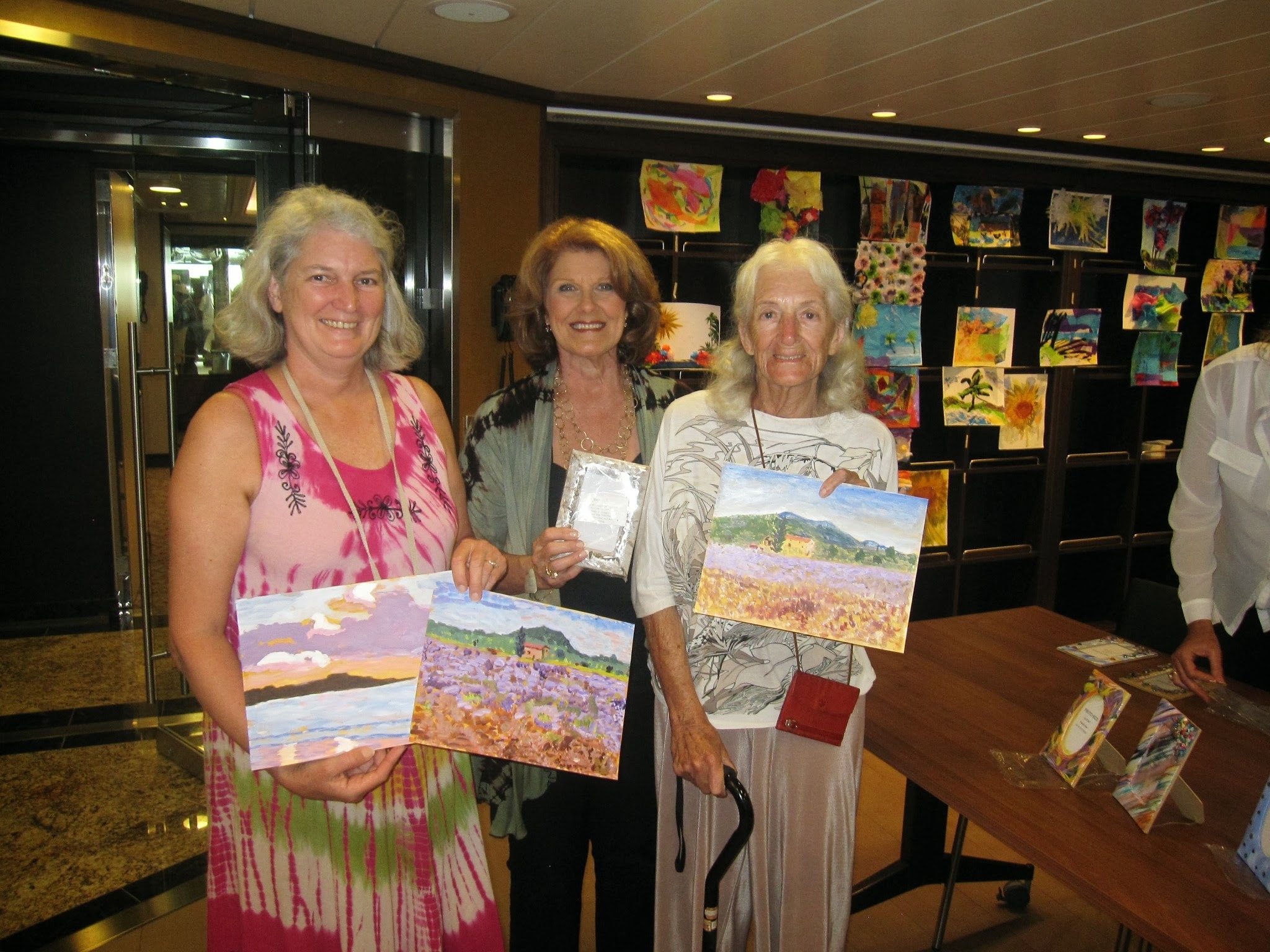 Artists displaying paintings at an art exhibition