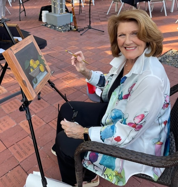 Pat Grillo painting at her easel